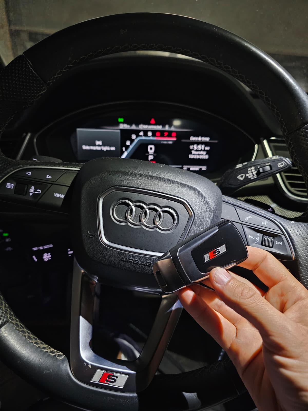 Audi steering wheel with Audi smart key fob , Texan Locksmith Houston Audi key replacement service