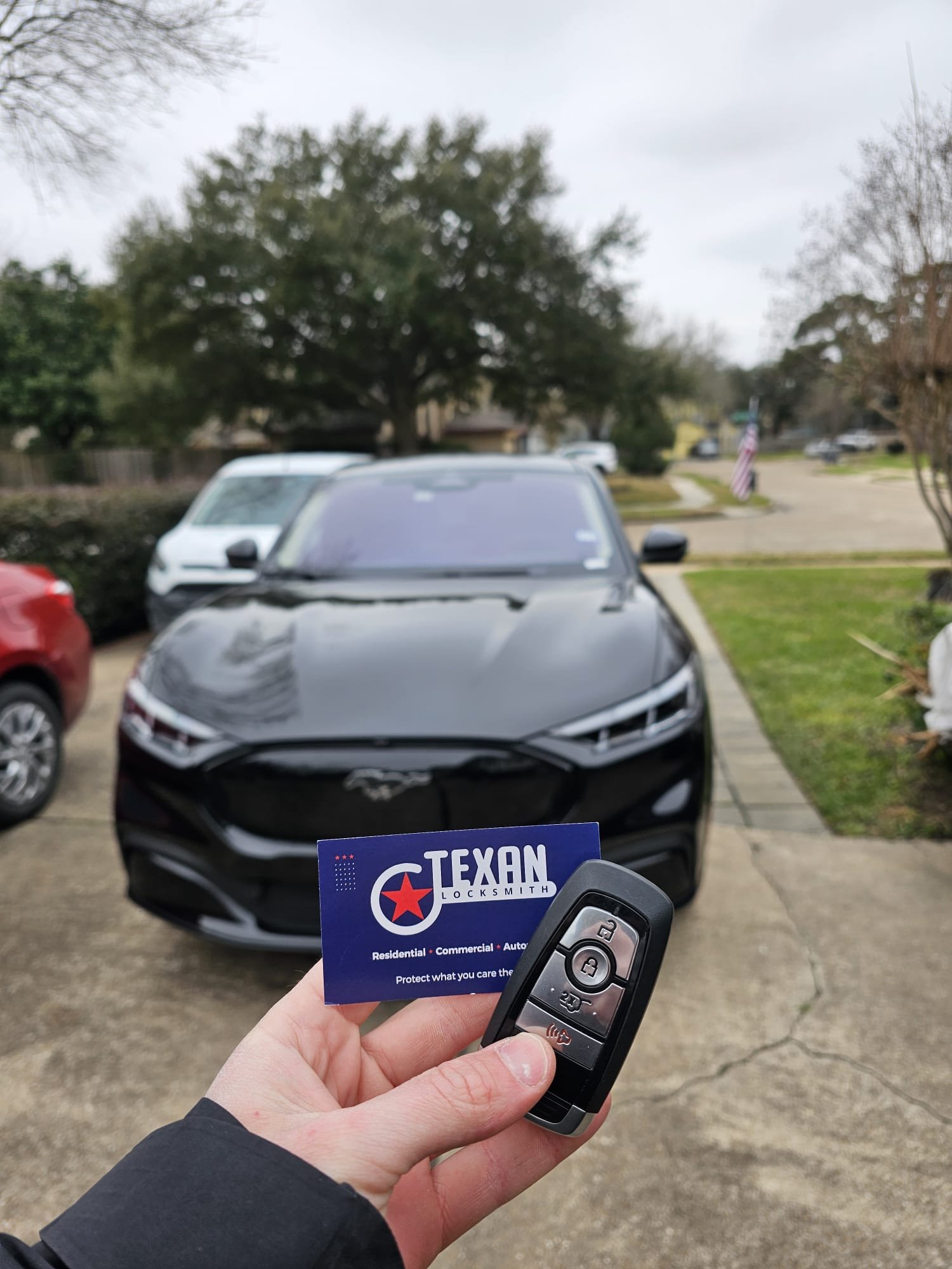 Ford Mustang Mach-E key fob replacement with Texan Locksmith business card