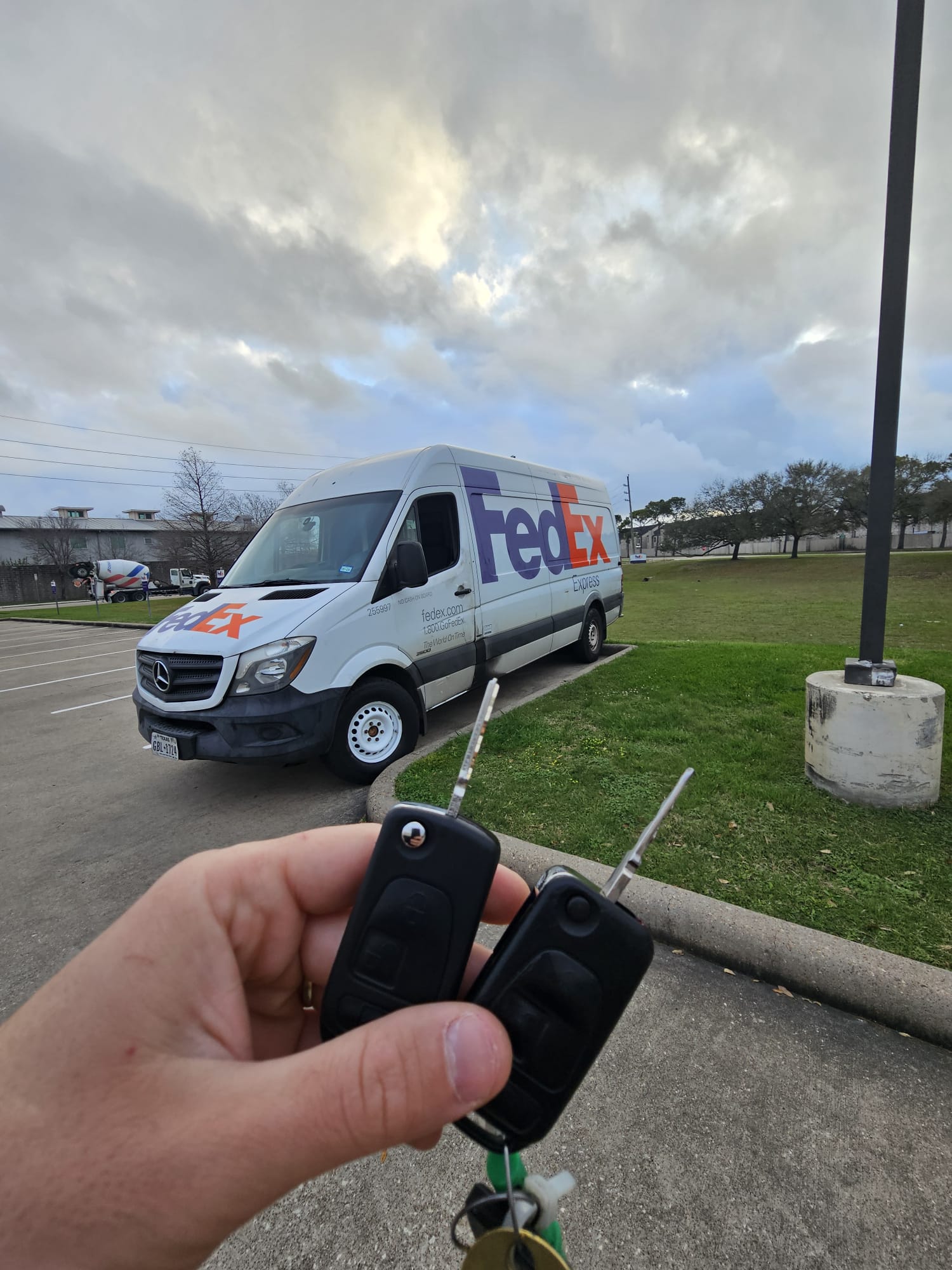 Texan Locksmith technician holding two new flip keys for Mercedes-Benz Sprinter van