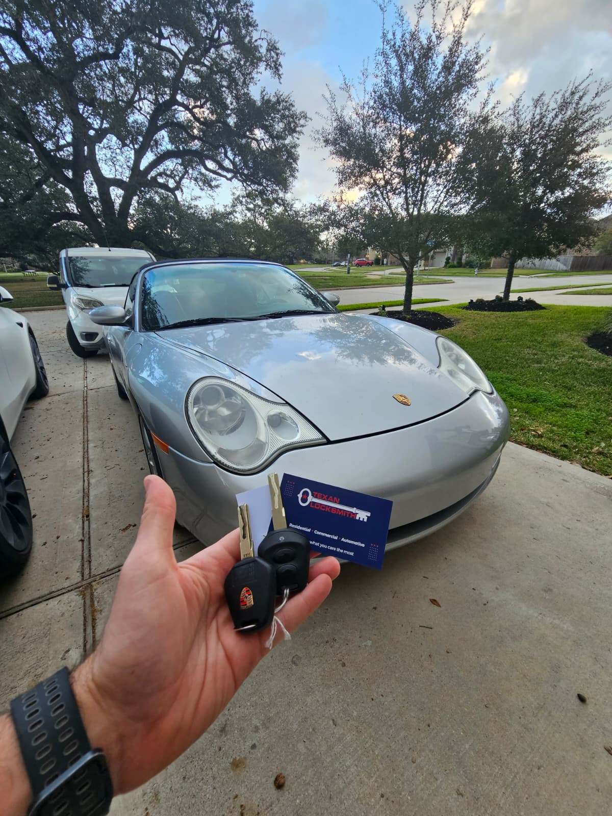 Porsche 911 key replacement at residential driveway , new Porsche transponder key and business card, Houston TX